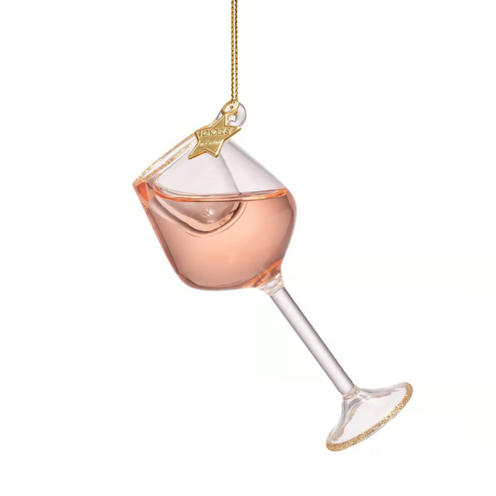 A clear glass martini-style hanging ornament filled with pale pink liquid, with a gold star topper and gold trim on the rim and stem, shown against a plain white background.