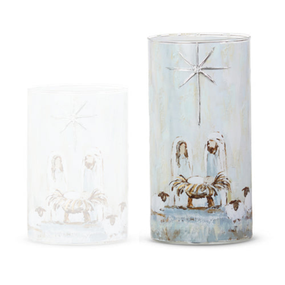 Large cylindrical glass container with a Nativity scene design, one with a light blue wash and the other clear/frosted, shown on a white background.