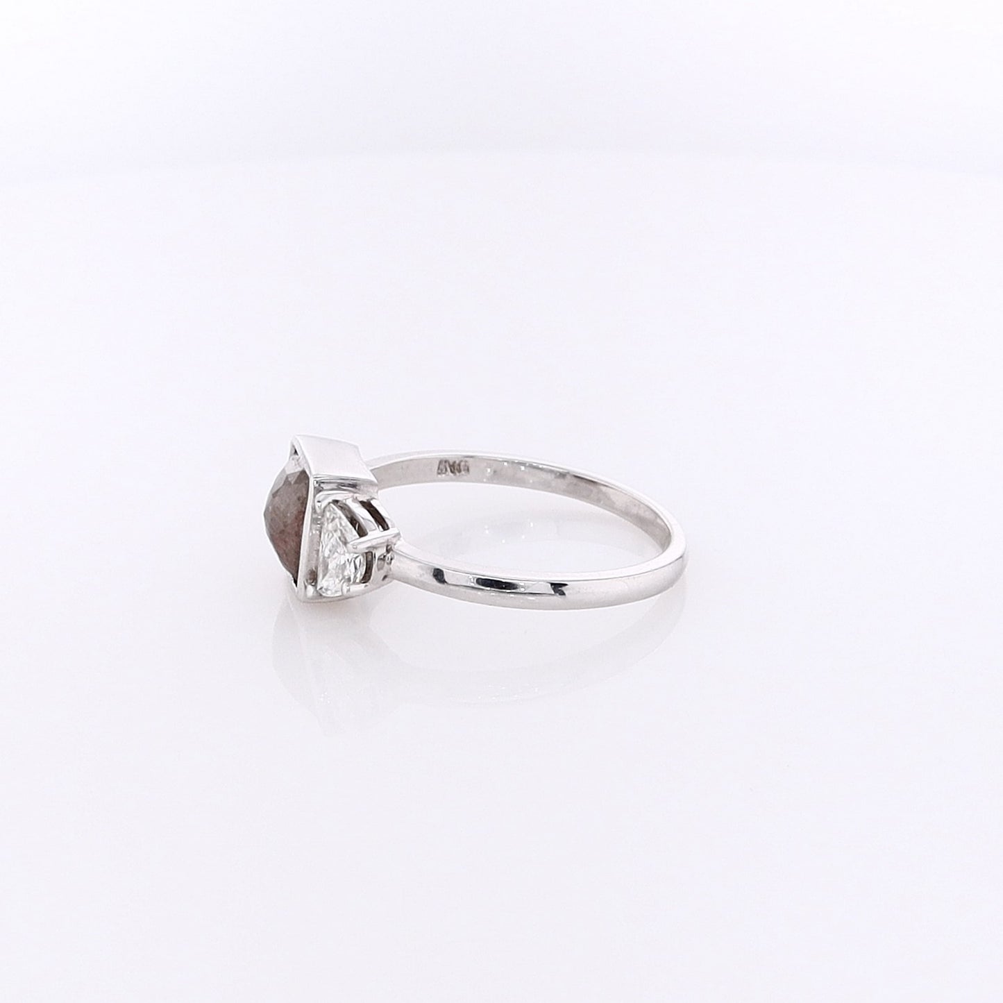 White gold ring with a salt & pepper diamond center with half moon cut diamond sides on a white background