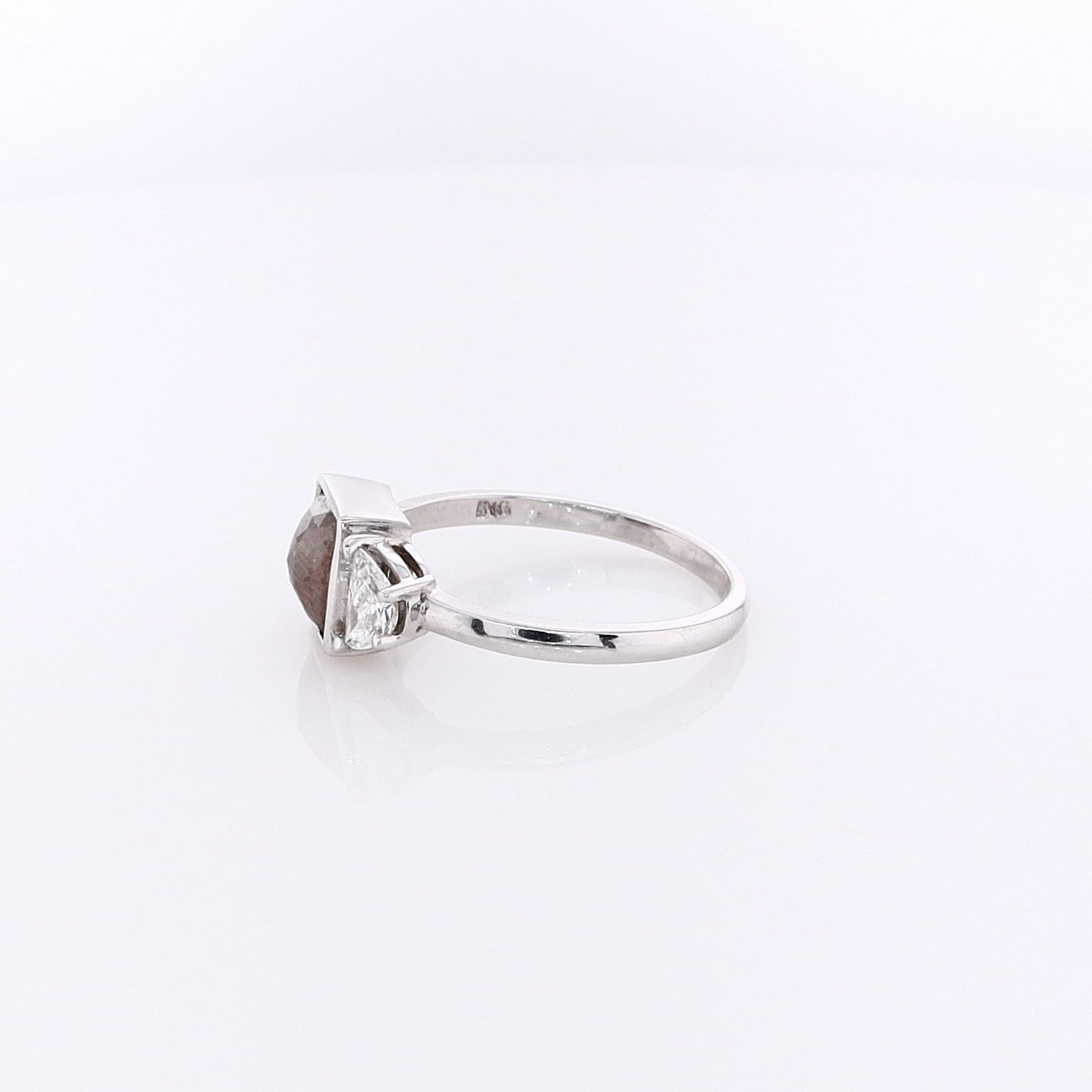 White gold ring with a salt & pepper diamond center with half moon cut diamond sides on a white background