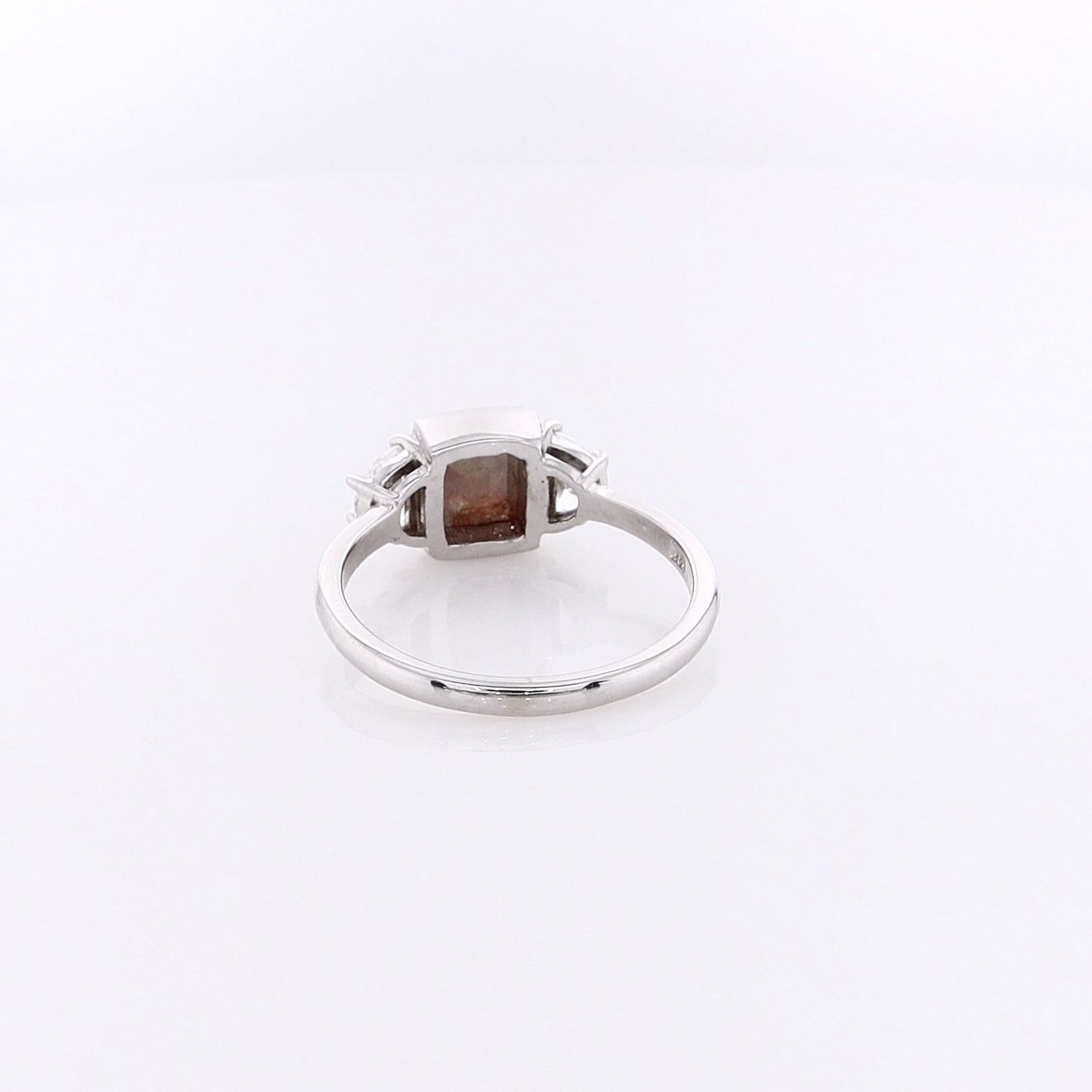 White gold ring with a salt & pepper diamond center with half moon cut diamond sides on a white background