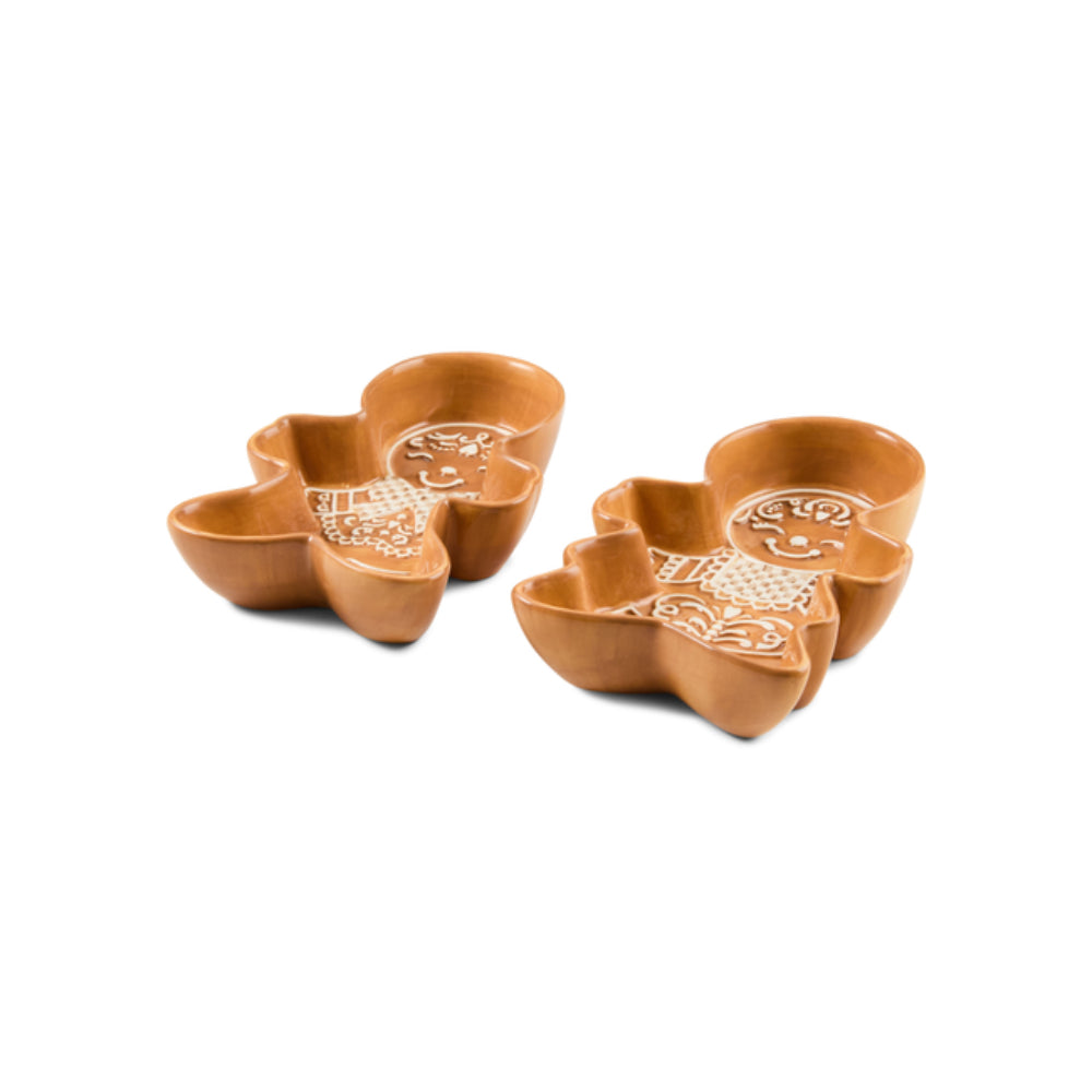 Two small gingerbread man ceramic bowls with white icing accents on a plain white background.