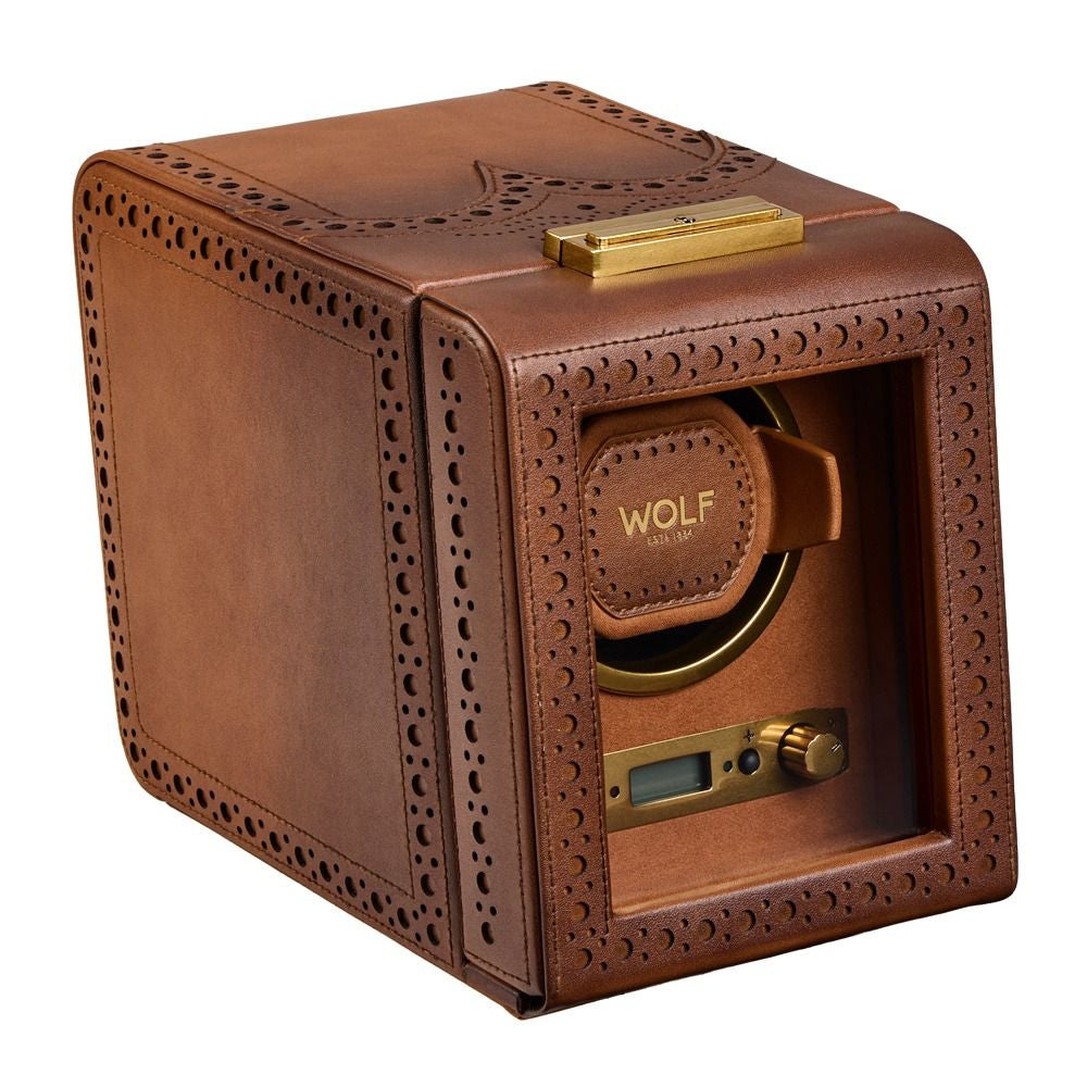 Brown leather watch winder with gold accents on a white background