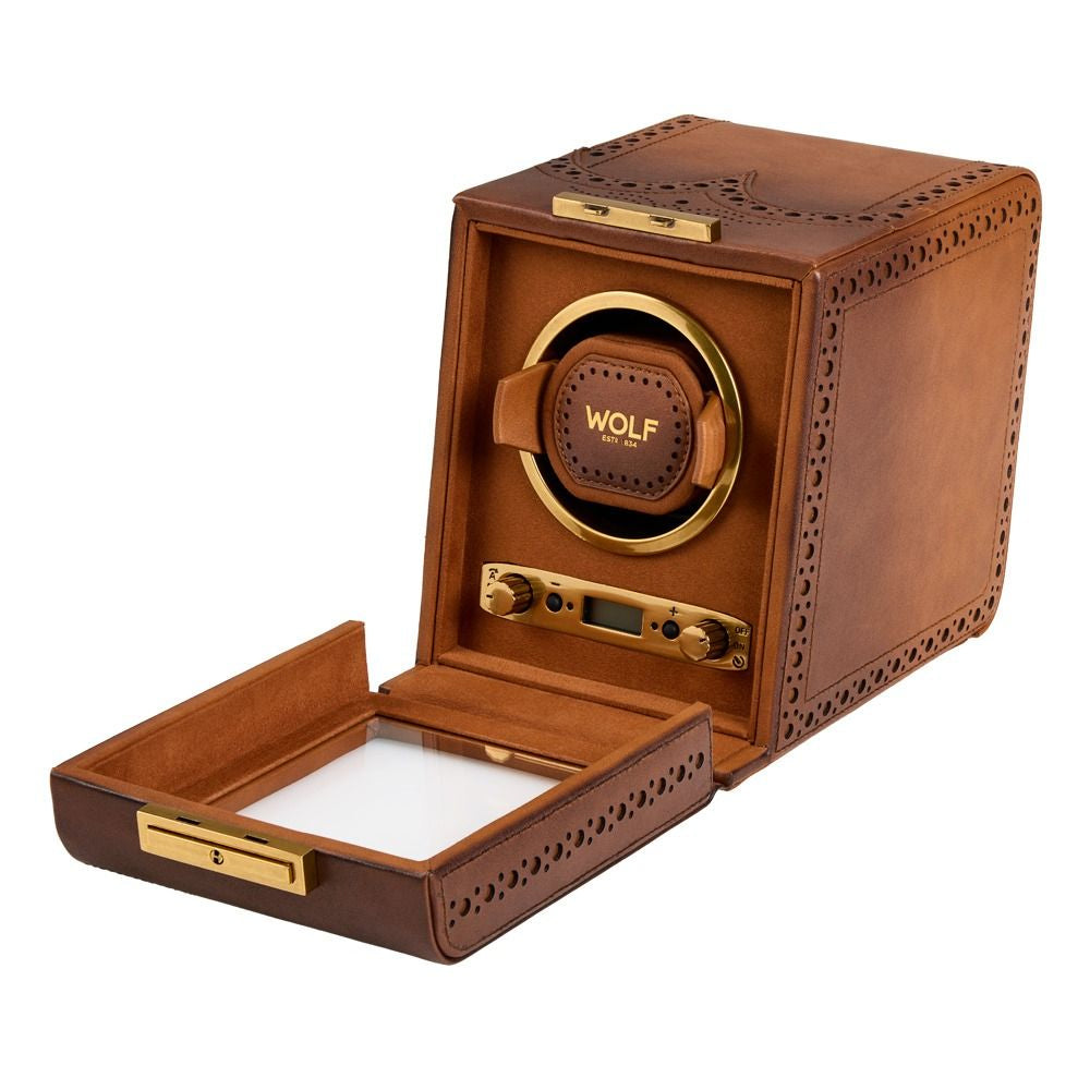 Brown leather watch winder with gold accents on a white background