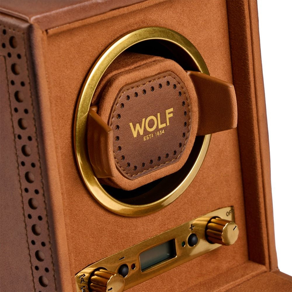 Wolf watch winder with gold accents and 'Wolf' branding on a brown background