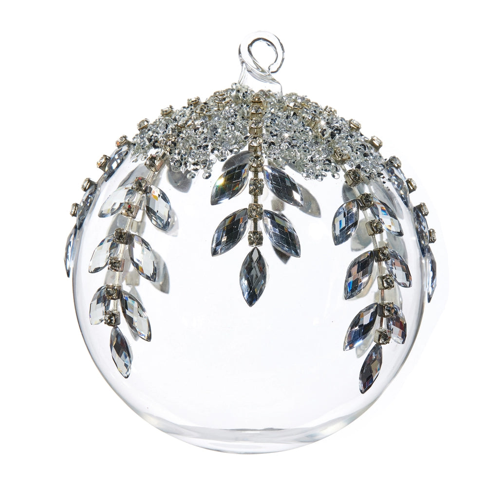 Decorative glass ball with silver leaf-like embellishments on a white background.
