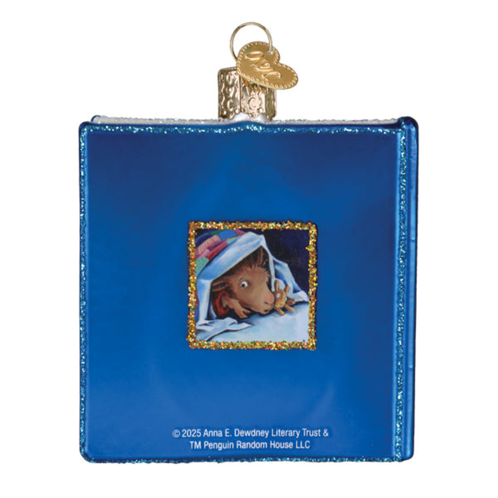 Blue book-shaped ornament with a small illustration of a bear peeking out, on a white background.