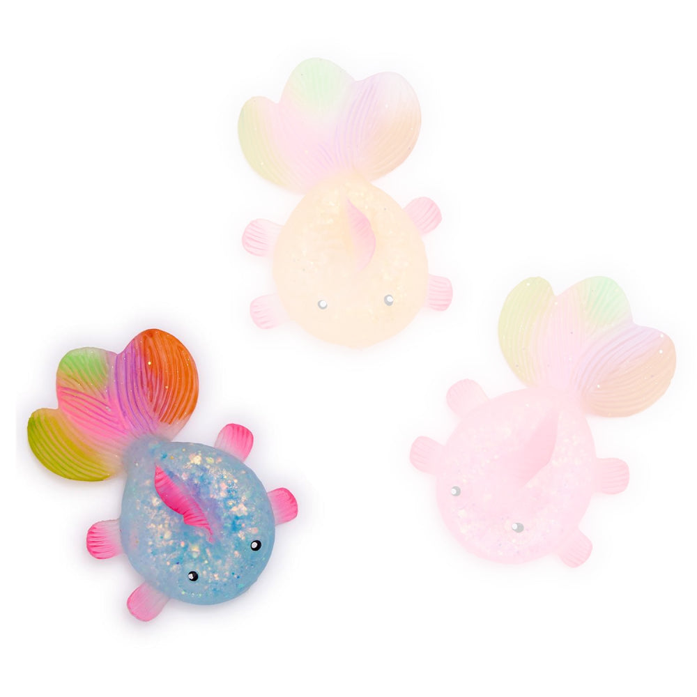 A photo of the blue squishy glitter fish toy with rainbow tail on a white backround 