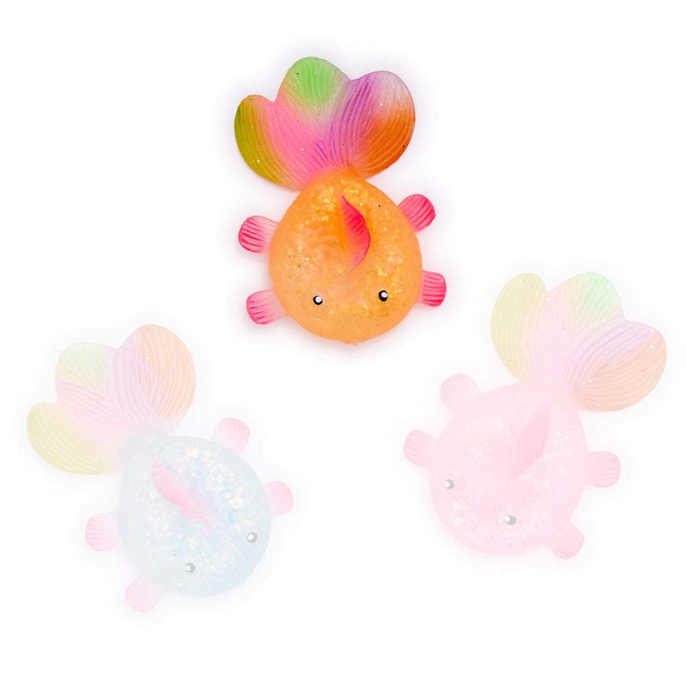 A photo of the orange squishy glitter fish toy with rainbow tail on a white backround 
