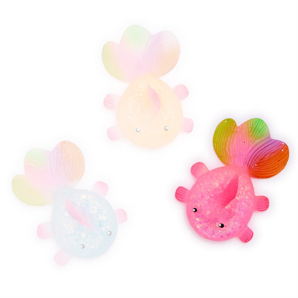 A photo of the pink squishy glitter fish toy with rainbow tail on a white backround 
