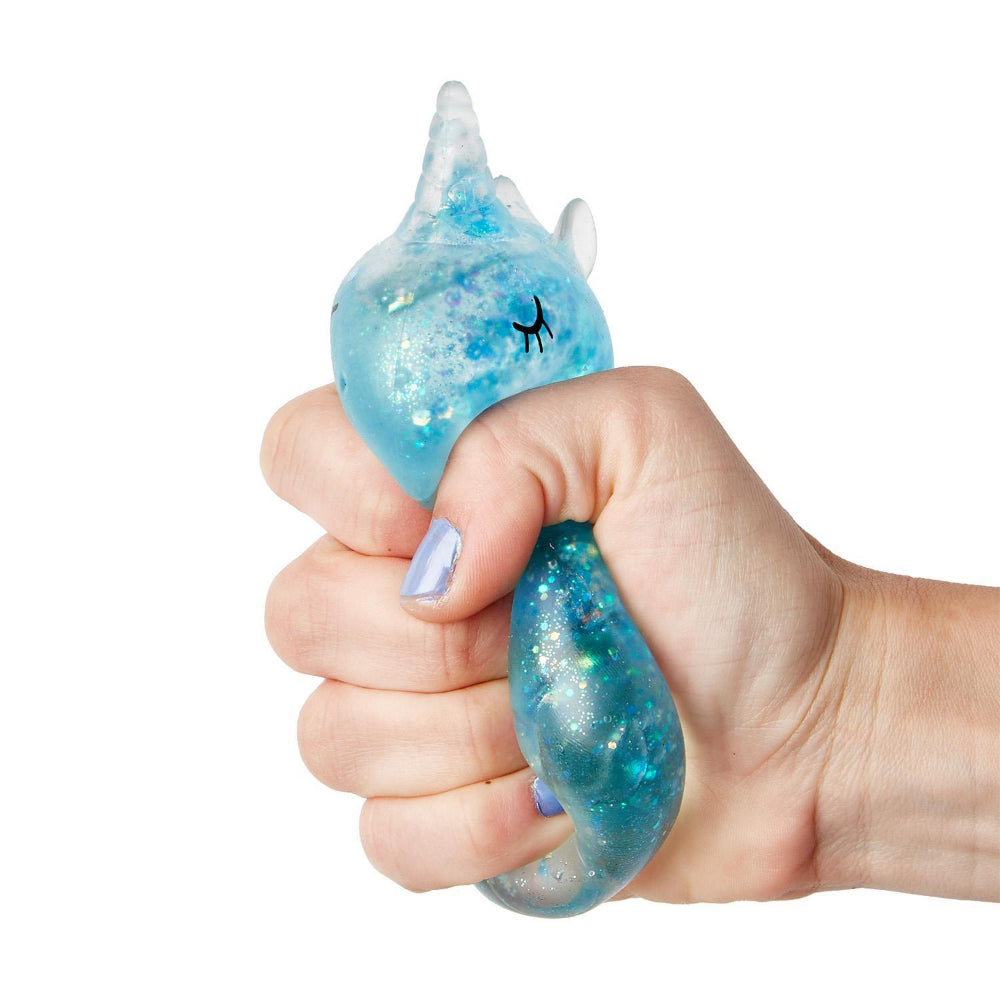 Hand holding a blue squishy glittery   toy as a stress ball, with a unicorn design on a white background