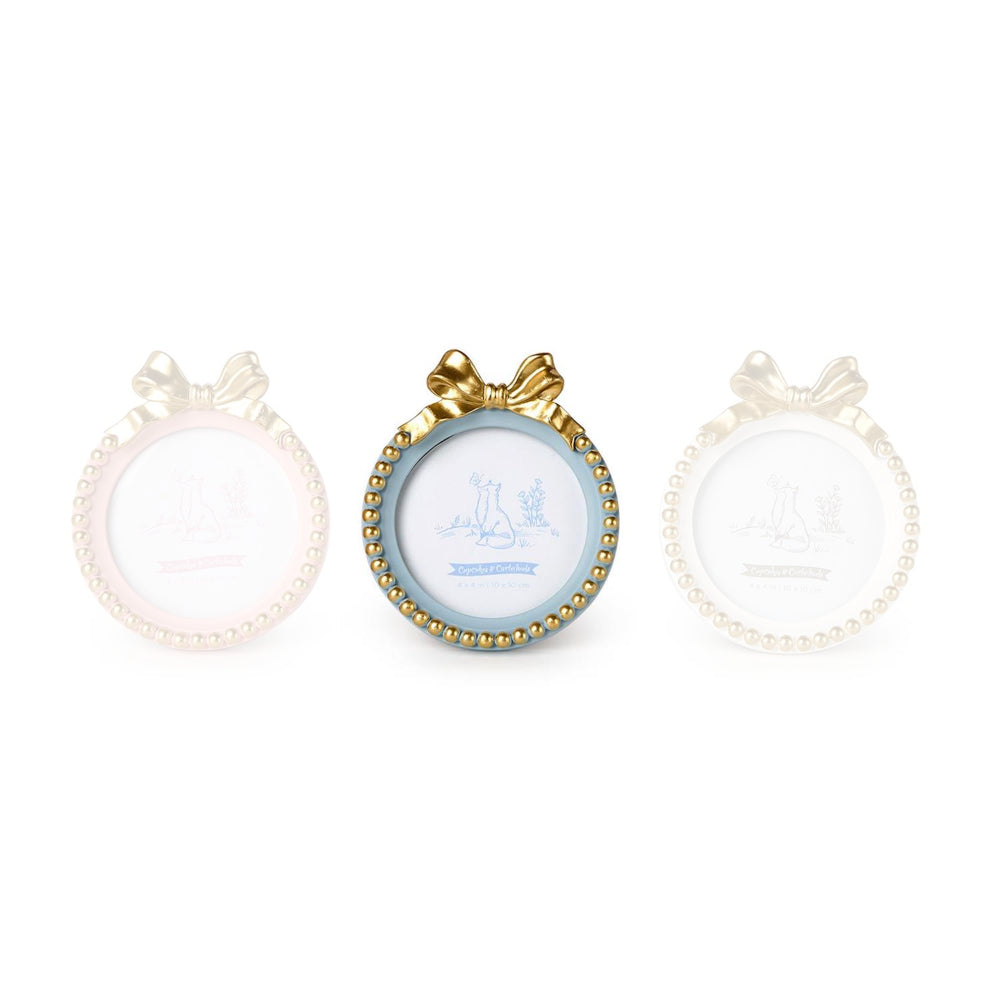 Blue round golden bow picture frame with a decorative bow and bead trim on a white backround. 