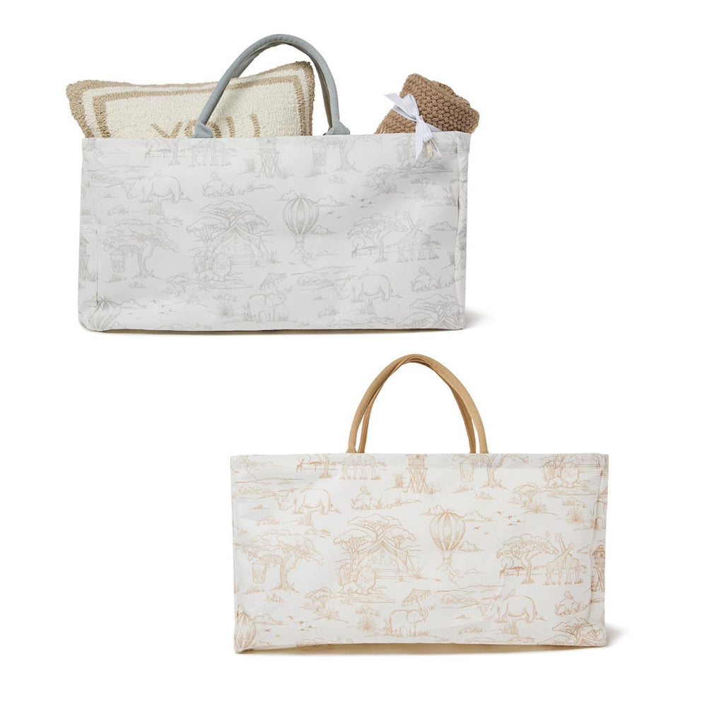 Two large fabric tote bags with handles with designs in Grey & White and Taupe & White with items in one pillow and blanket on a white background
