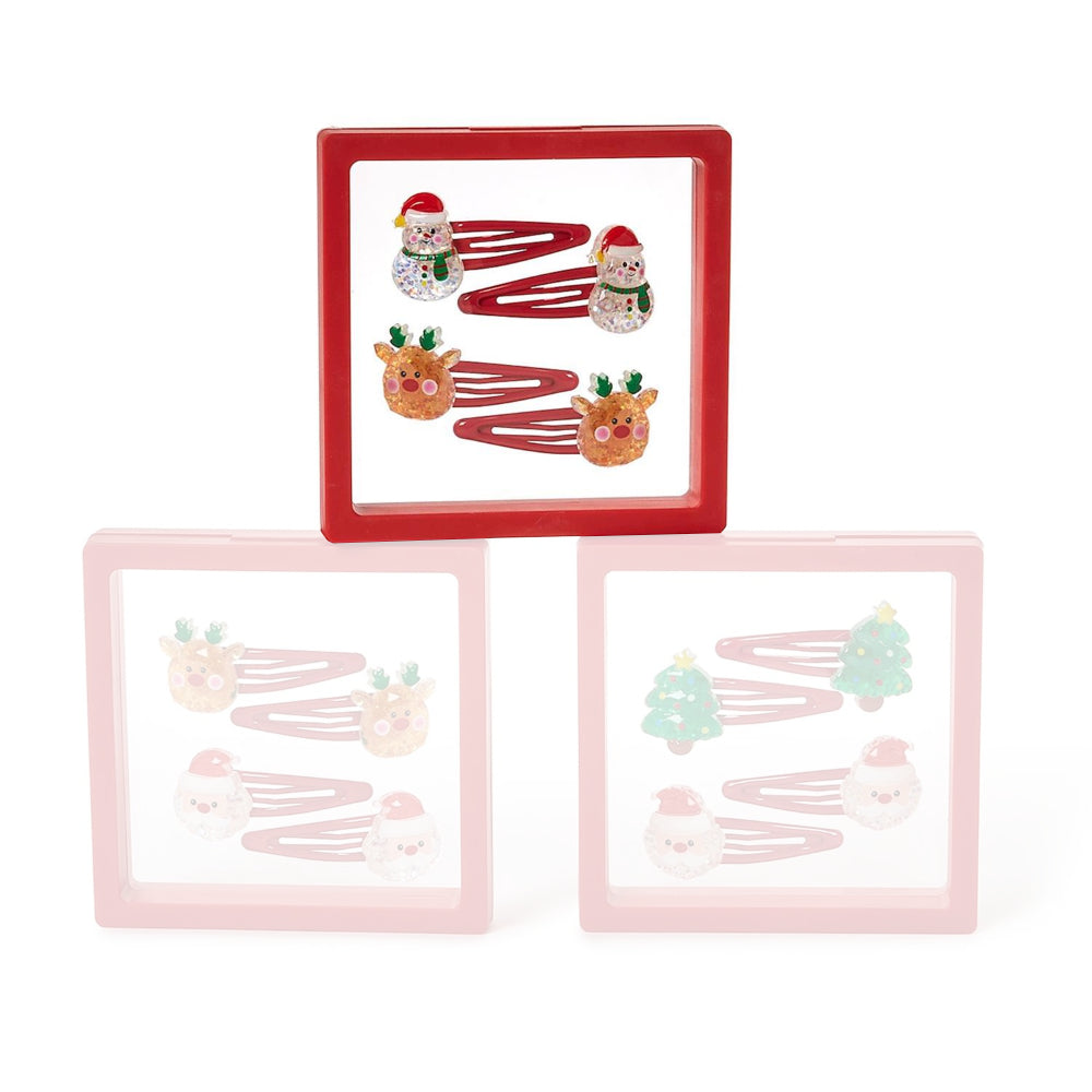 Set of four christmas-themed snowman & santa hair clips in clear packaging with a red boarder on a white background.