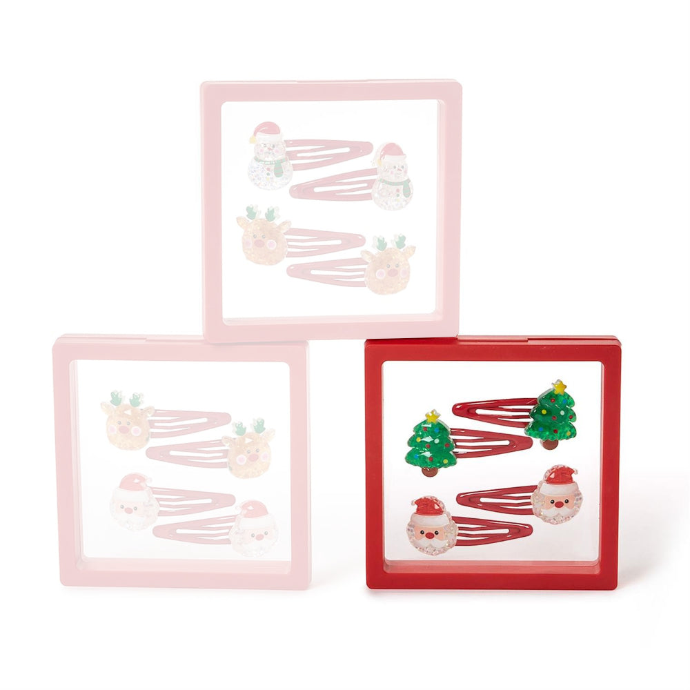 Set of four christmas-themed chrismas tree & santa hair clips in clear packaging with a red boarder on a white background.