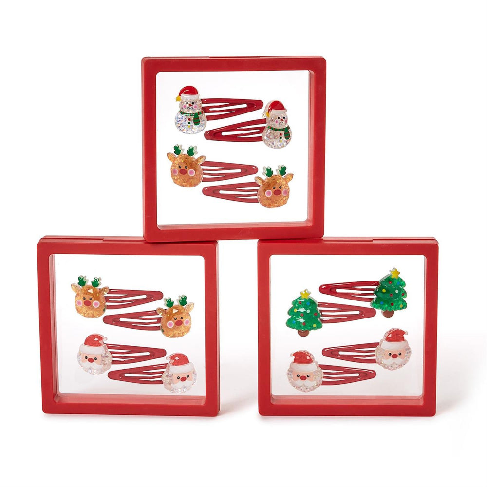 Three sets of christmas-themed hair clips Santa, reindeer, snowman and trees in clear packaging with a red boarder on a white background.