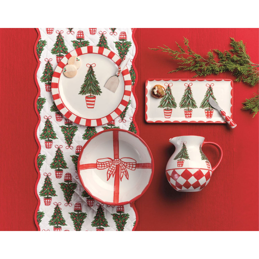 Christmas-themed tableware set with tree and bow designs on a red background
