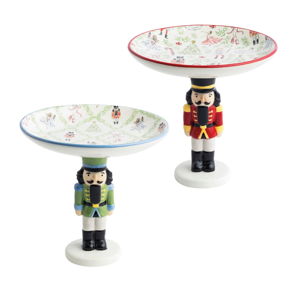 Two decorative plates with nutcracker designs on a white background