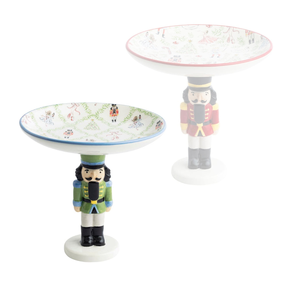 Two decorative nutcracker stands with intricate designs on a white background