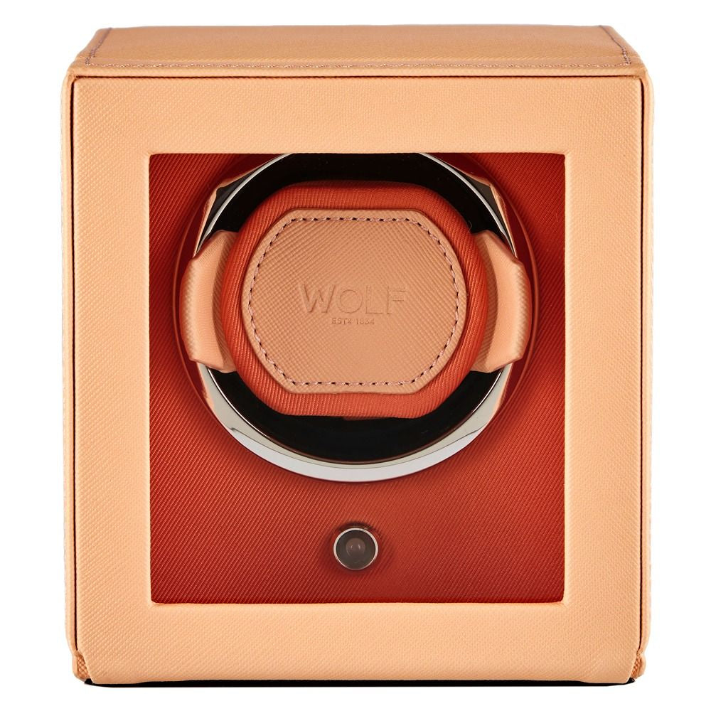 Watch winder with 'WOLF' branding in a peach-colored box on a white background