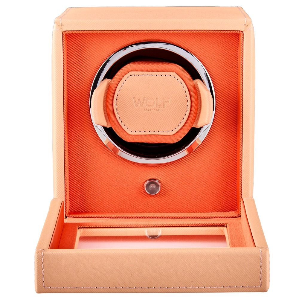 Watch winder with orange interior and beige exterior on a white background
