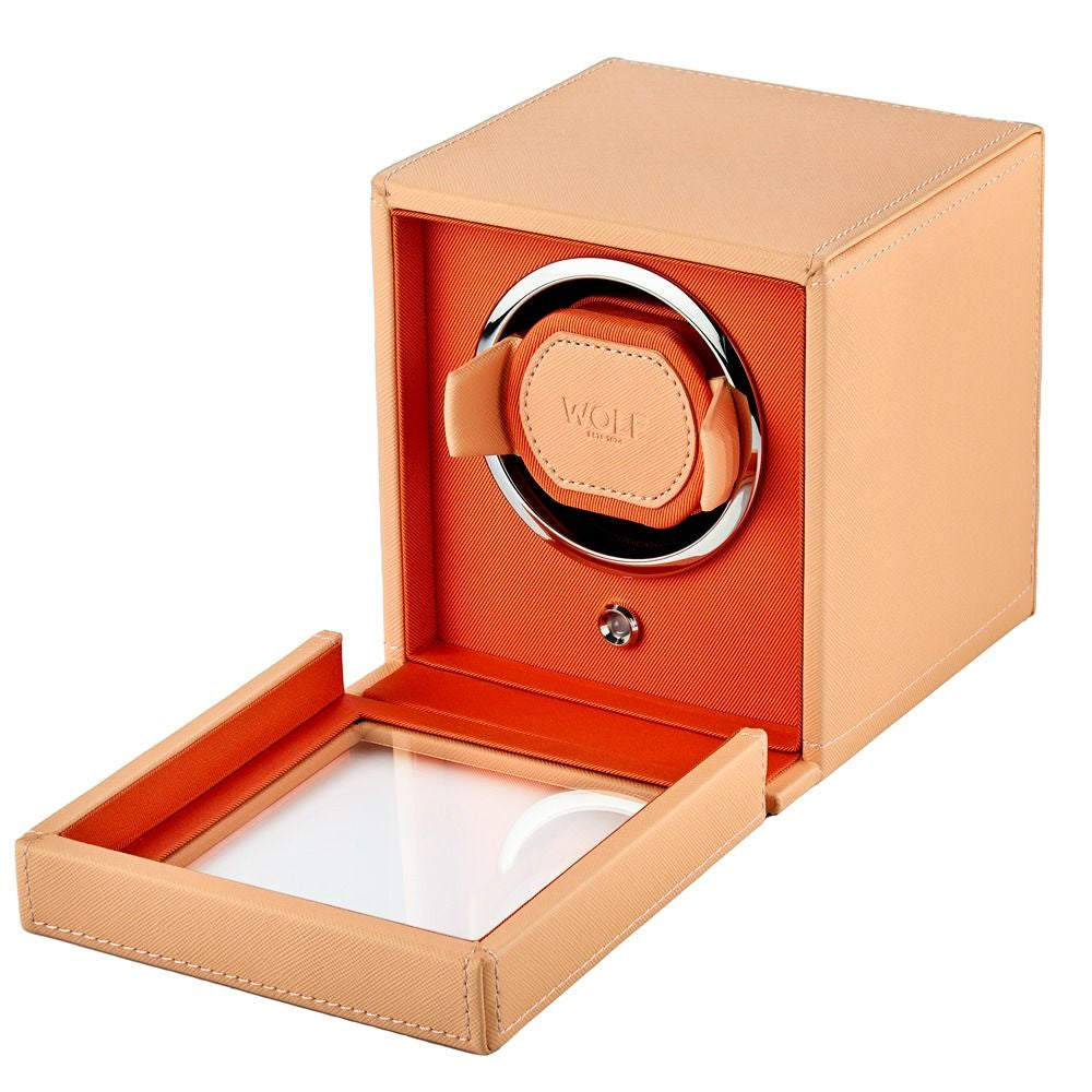 Orange watch winder with a white interior on a white background