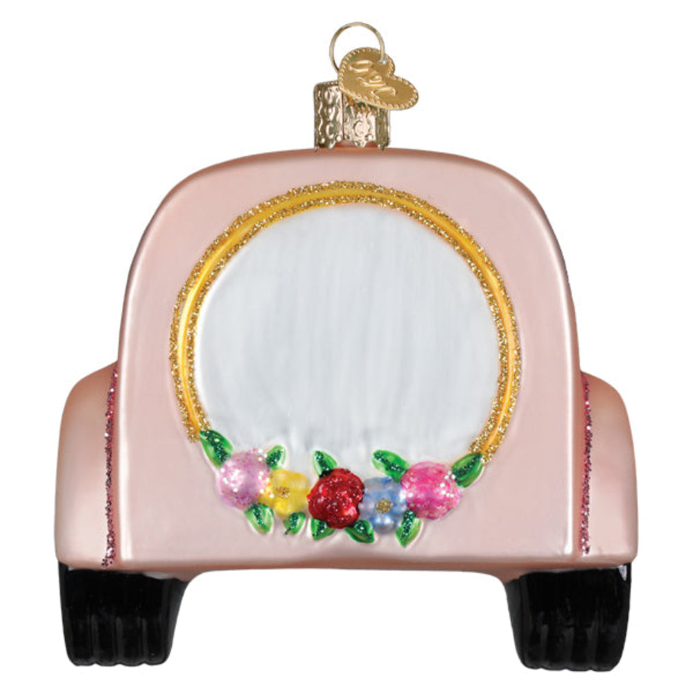 Decorative pink car ornament with flowers on a white background