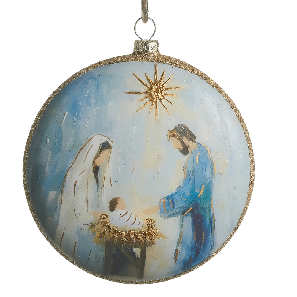 Round Christmas ornament with nativity scene featuring Mary, Joseph, and baby Jesus.