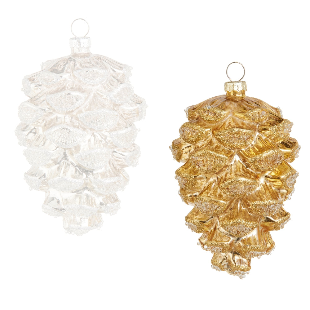 Two Christmas ornaments, one white and one gold, on a white background