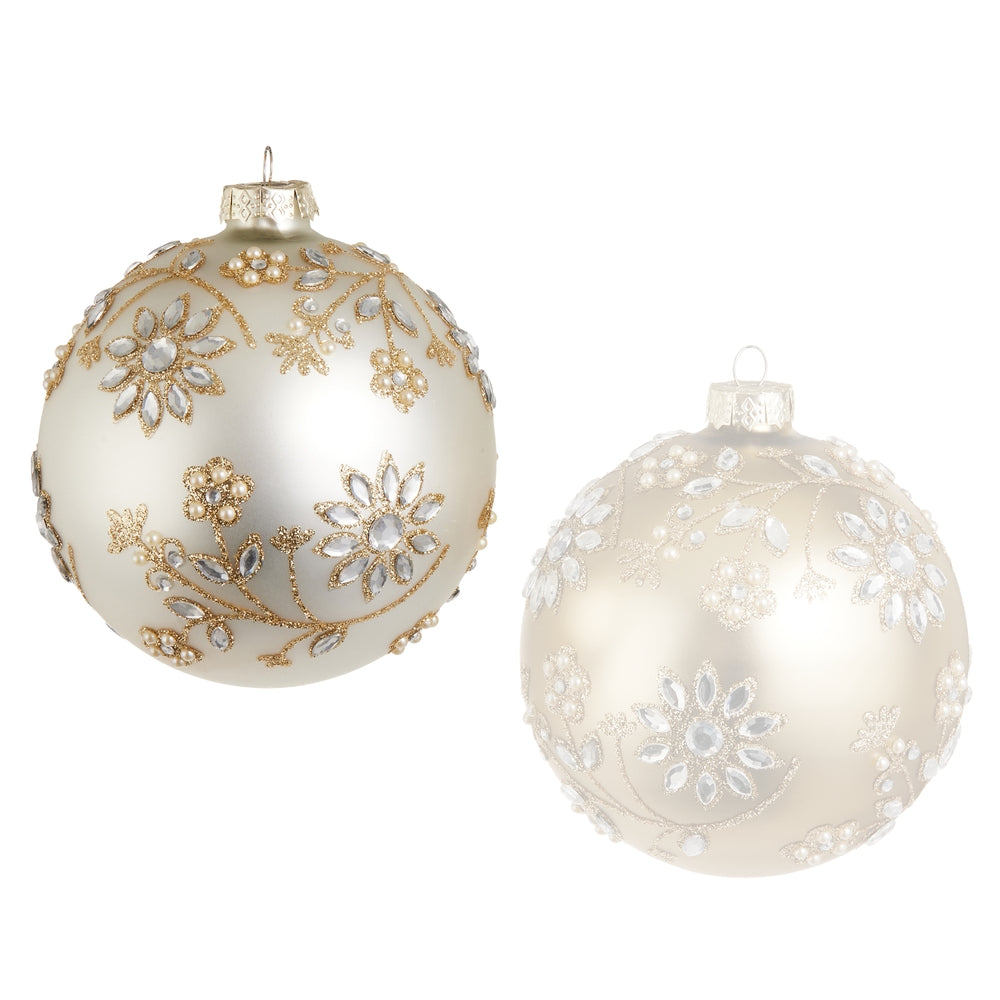 White decorative Christmas ball with gold floral patterns and snowflake designs on a white background.