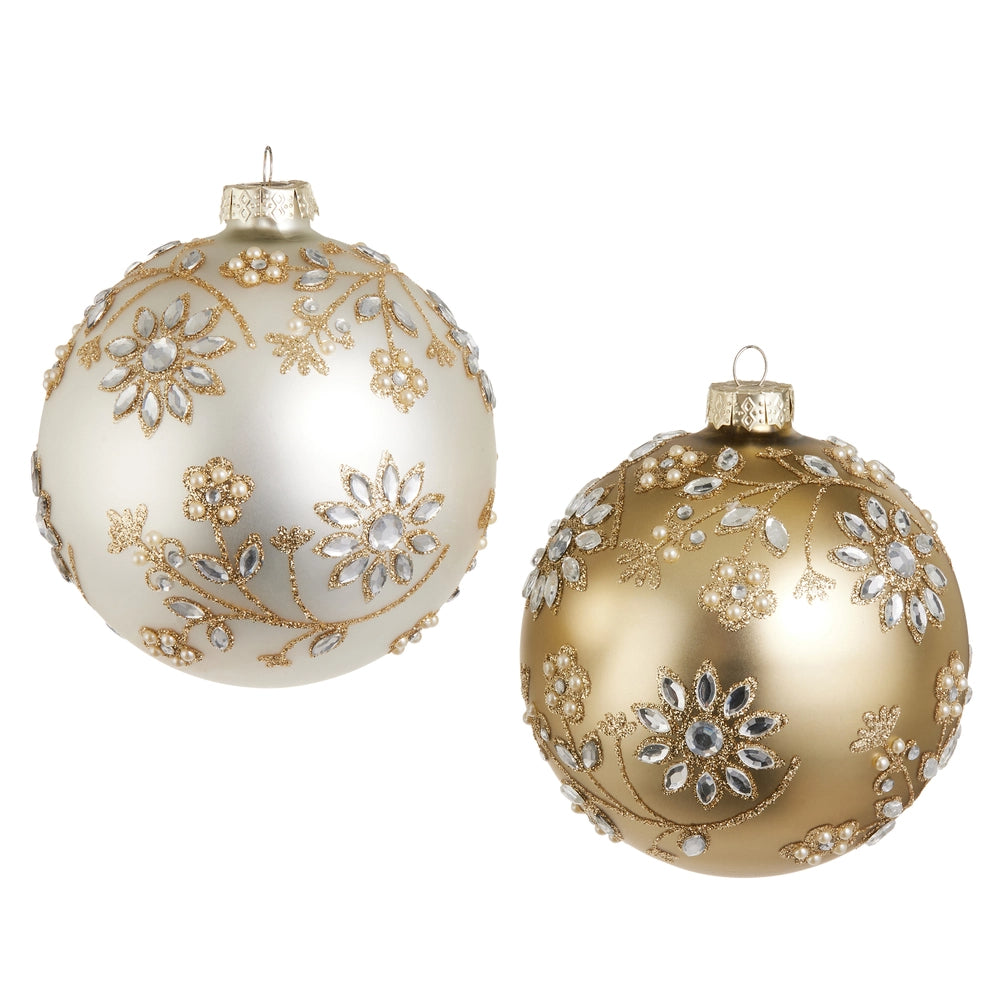 Two ornate Christmas ornaments, one white and one gold, with floral patterns on a white background.