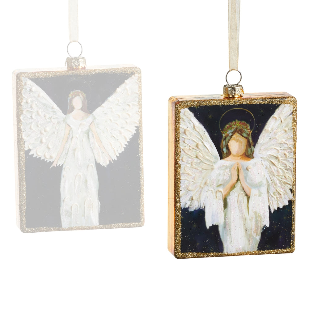 Two angel ornaments with white wings on a white background