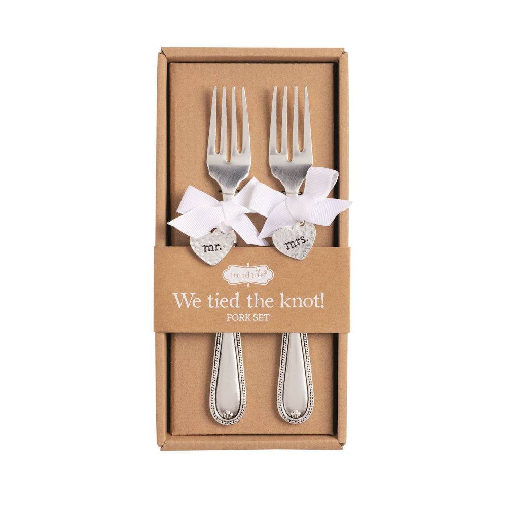 A boxed silver-toned fork set with white ribbons and heart charms reading 'mr.' and 'mrs.