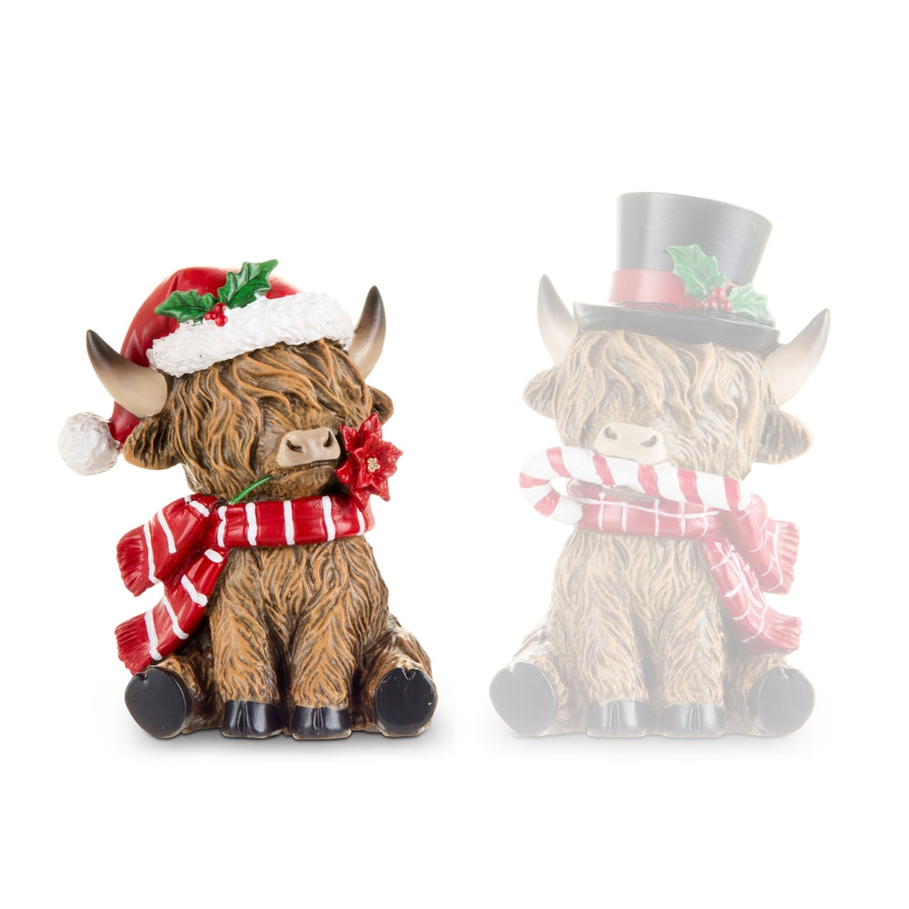 Two decorative figurines of bulls wearing festive hats and scarves on a white background