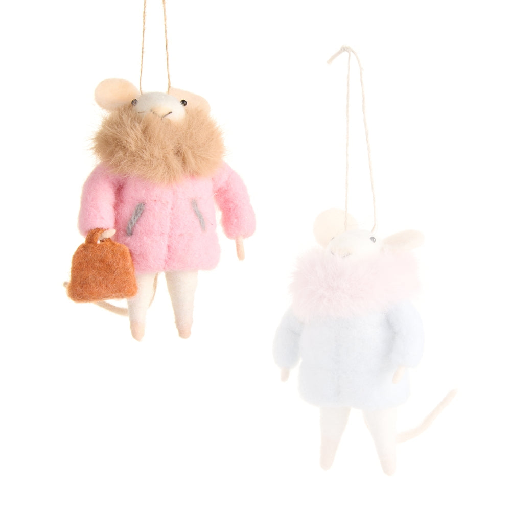 Small plush mouse toy wearing a pink coat and holding a brown bag on a white background