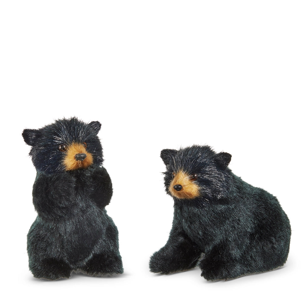 Two black bear ornaments with brown faces on a white background