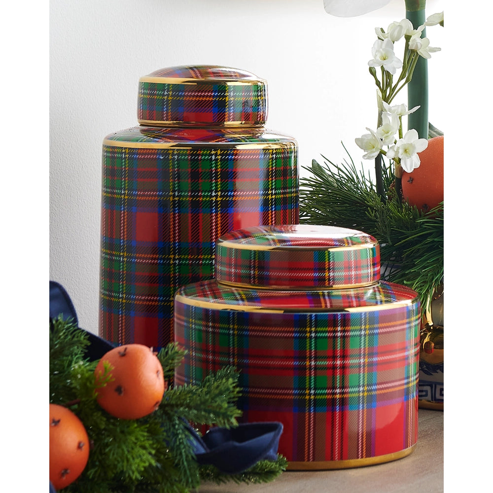 Set of three plaid-patterned cylindrical containers with a decorative background.