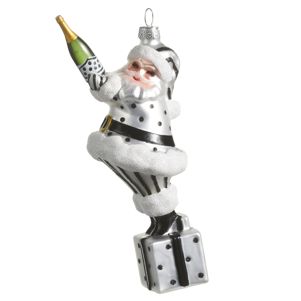 Decorative glass ornament of a modern Santa Claus holding a bottle on a white background