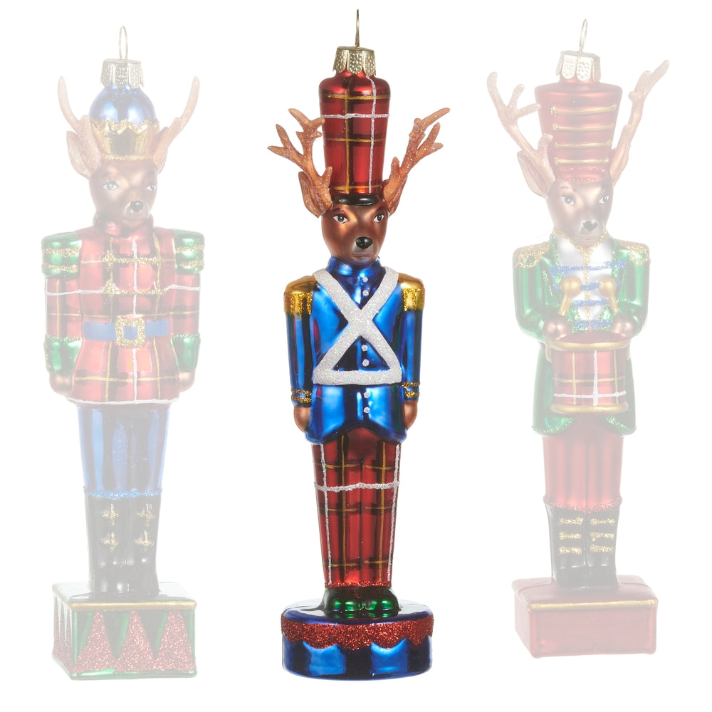 Blue glass reindeer ornaments in Nutcracker costumes on a white background.