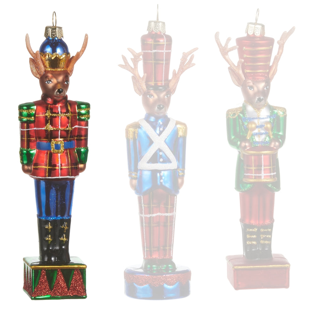 Red glass reindeer ornaments in Nutcracker costumes on a white background.