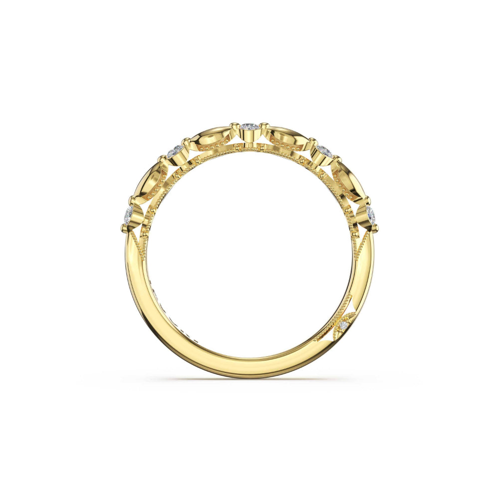 A yellow gold ring with a decorative pattern of small clear stones along the band, shown from a top-down view on a white background.
