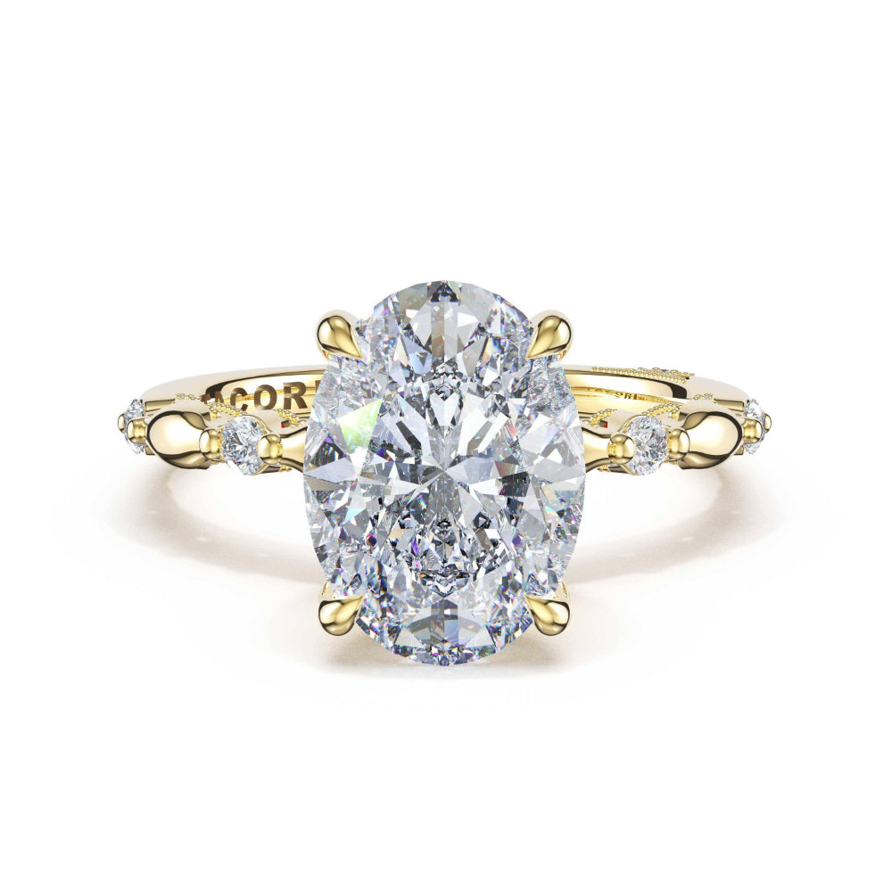 Gold ring with a large diamond and smaller diamonds on the band against a white background