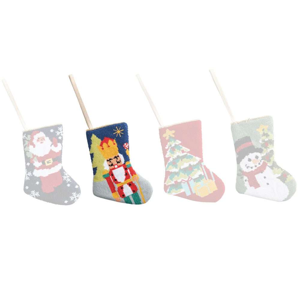 Set of four Christmas-themed stockings with Santa, Nutcracker, tree, and snowman designs on a white background.