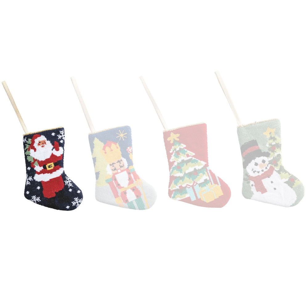 Set of four small Christmas stockings with festive designs on a white background