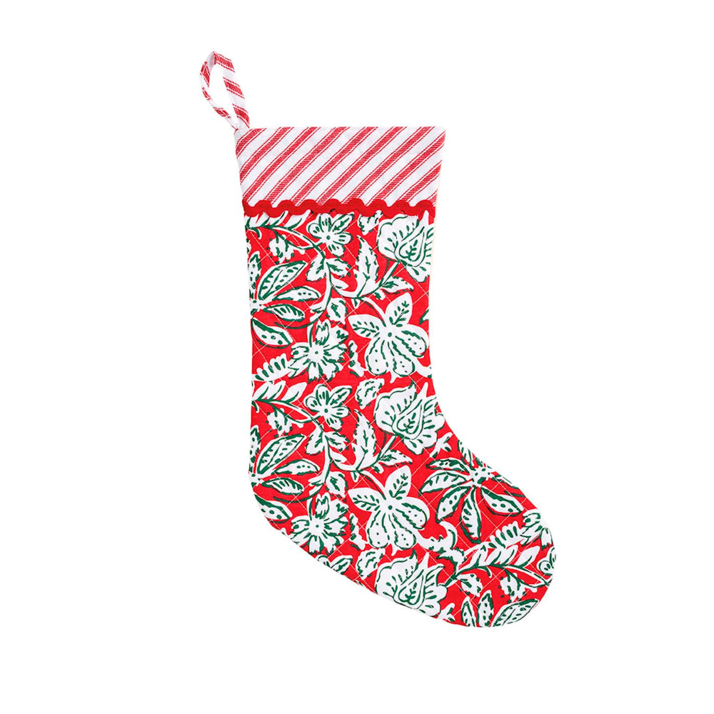 A Christmas stocking with a red and white striped cuff and a red body featuring a white floral and leaf pattern, shown on a plain white background.