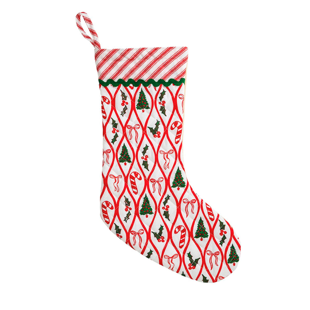 A Christmas stocking with a red and white striped cuff, featuring a repeating pattern of red bows, green Christmas trees, and candy canes on a white background, with a red-and-white striped hanging loop.