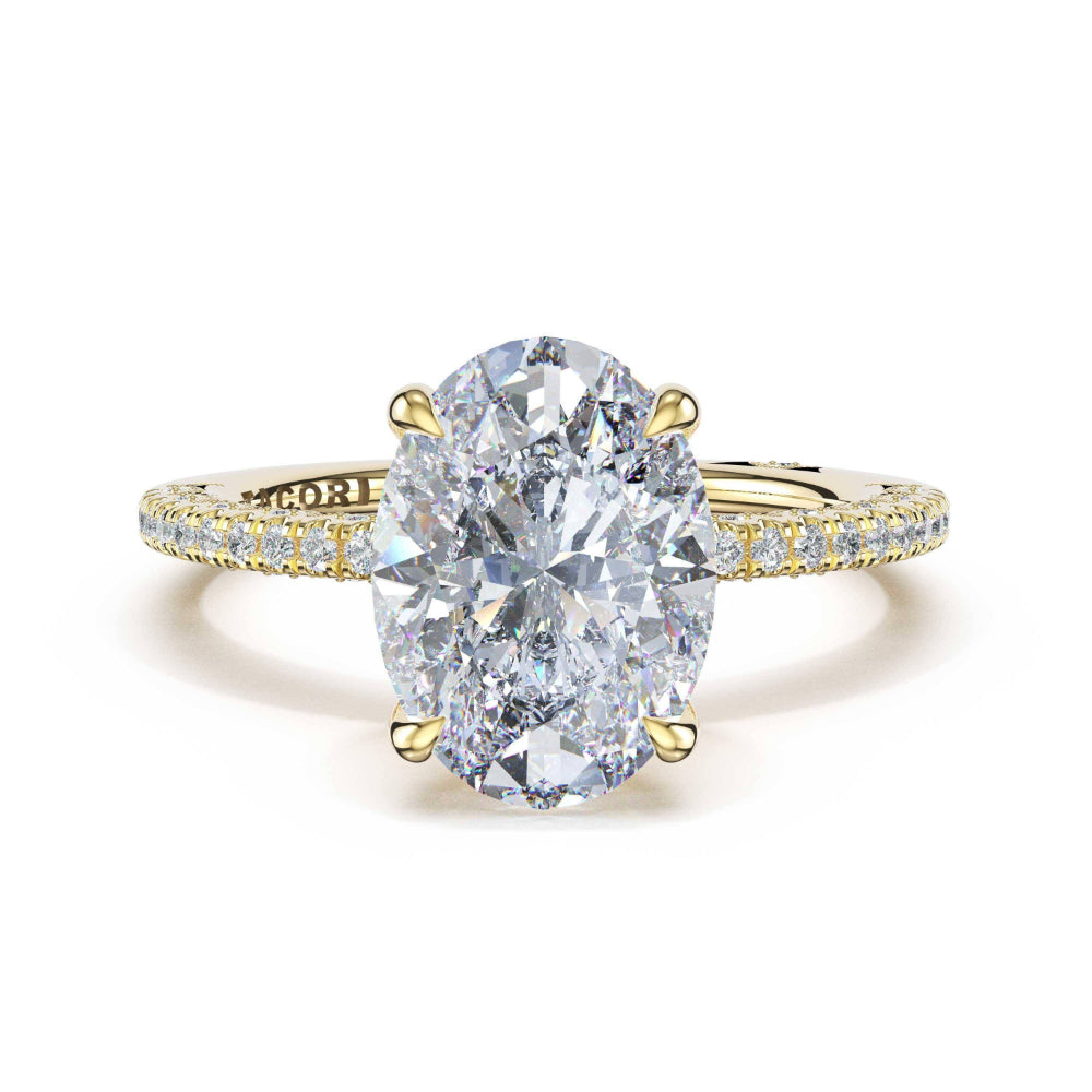 Gold ring with a large diamond and smaller diamonds on the band against a white background
