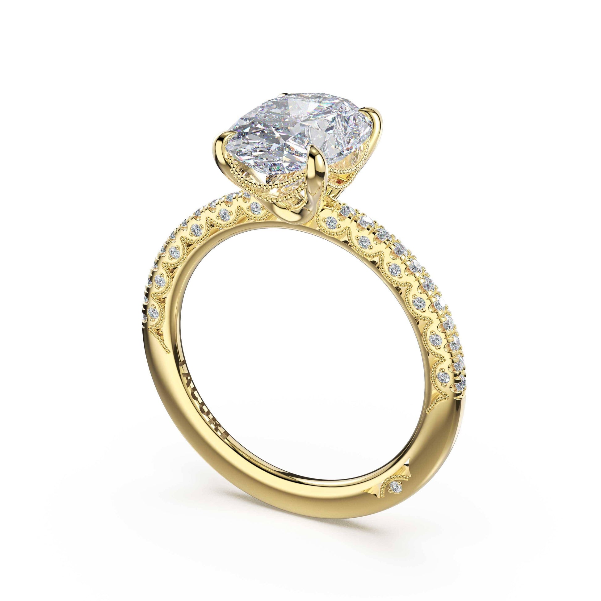 A yellow gold engagement ring featuring a large cushion-cut clear gemstone in a four-prong setting, with a pavé band accented by small round diamonds, shown on a white background.