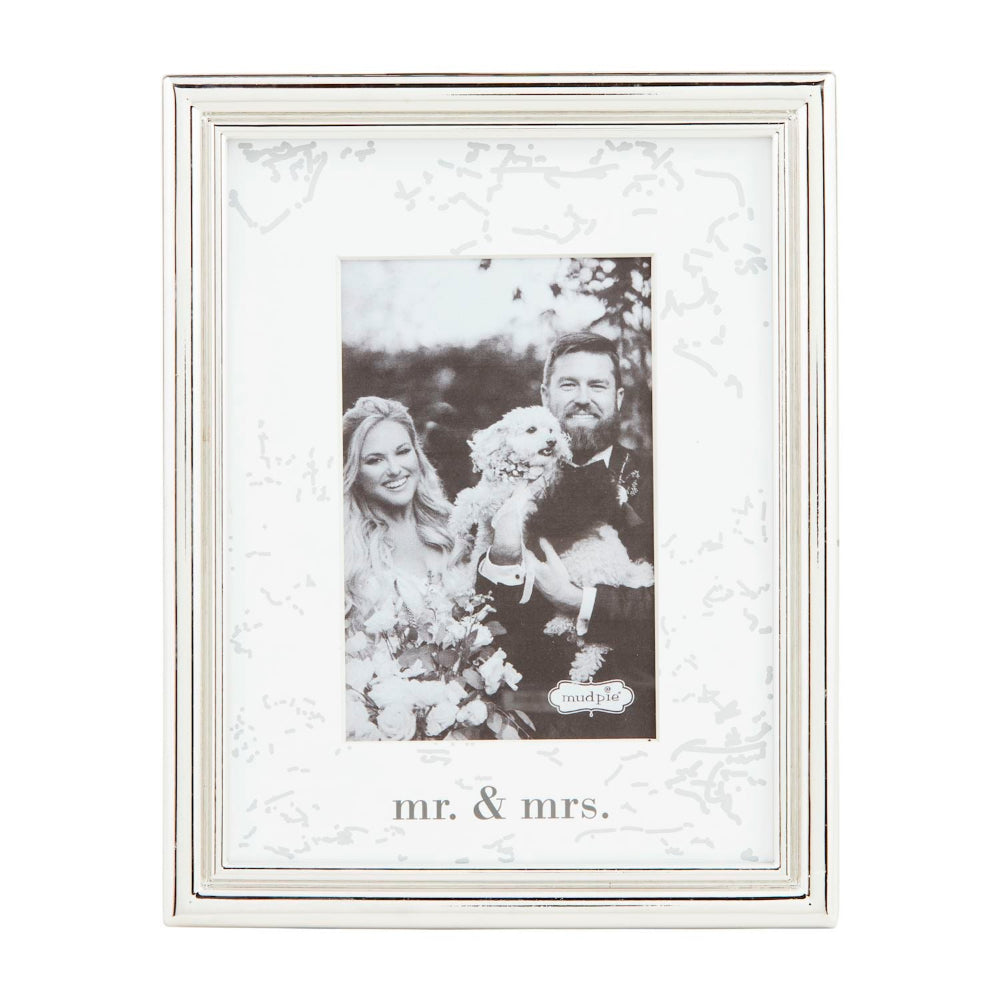 Decorative photo frame with 'mr. & mrs.' text and a couple holding a dog inside.