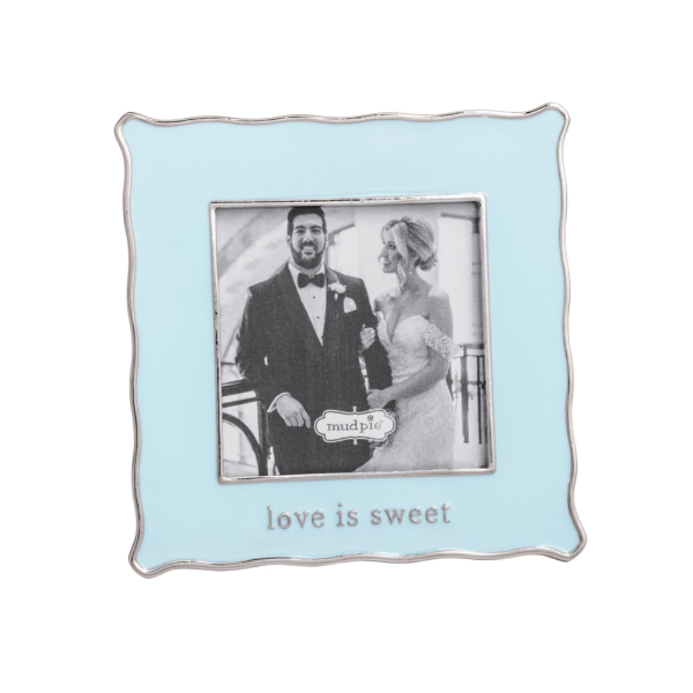 Light blue picture frame with a couple photo and 'love is sweet' text on a white background.